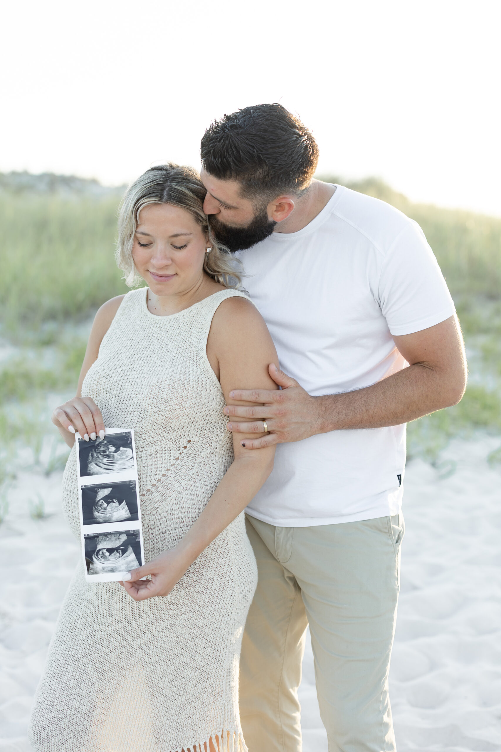 An image of a pregnant mama and her husband during her maternity session on Island Beach State Park. She was photographed by Natalie Beach Photography, a South Jersey Family Photographer.