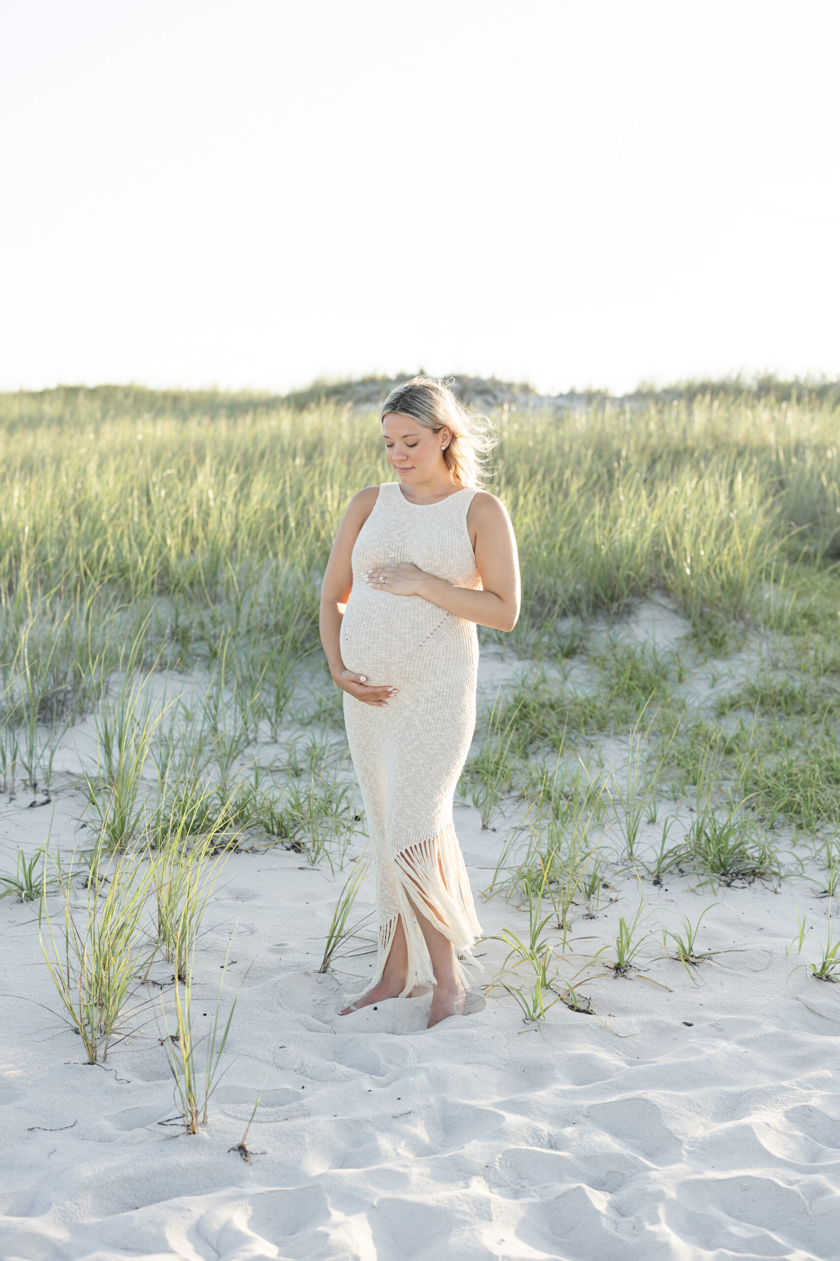 An image of a pregnant mama during her maternity session on Island Beach State Park. She was photographed by Natalie Beach Photography, a South Jersey Family Photographer.