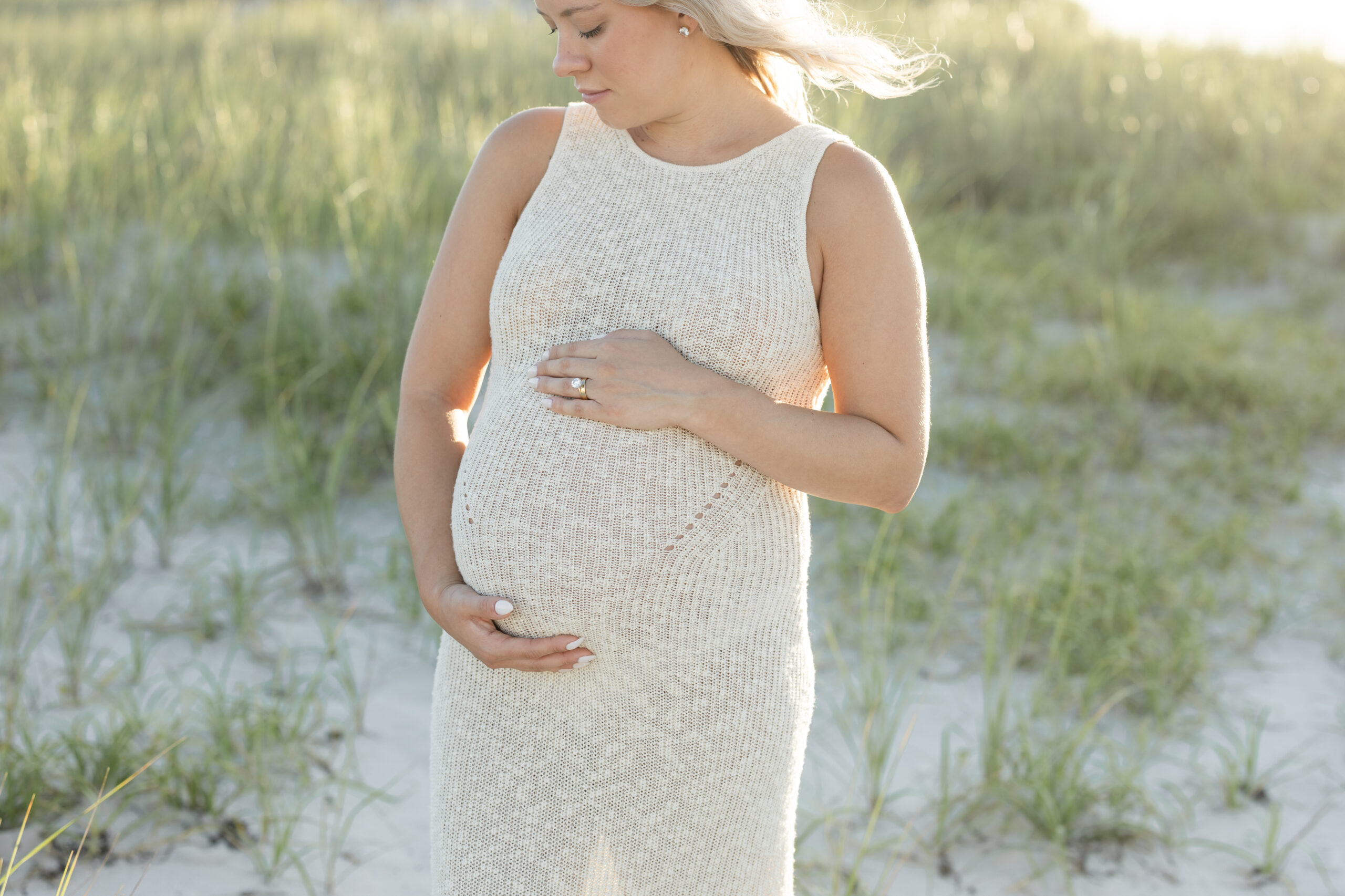 An image of a pregnant mama during her maternity session on Island Beach State Park. She was photographed by Natalie Beach Photography, a South Jersey Family Photographer.